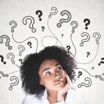 African woman wearing white shirt leans her chin on the palm of her hand. Around her head are drawings of question marks